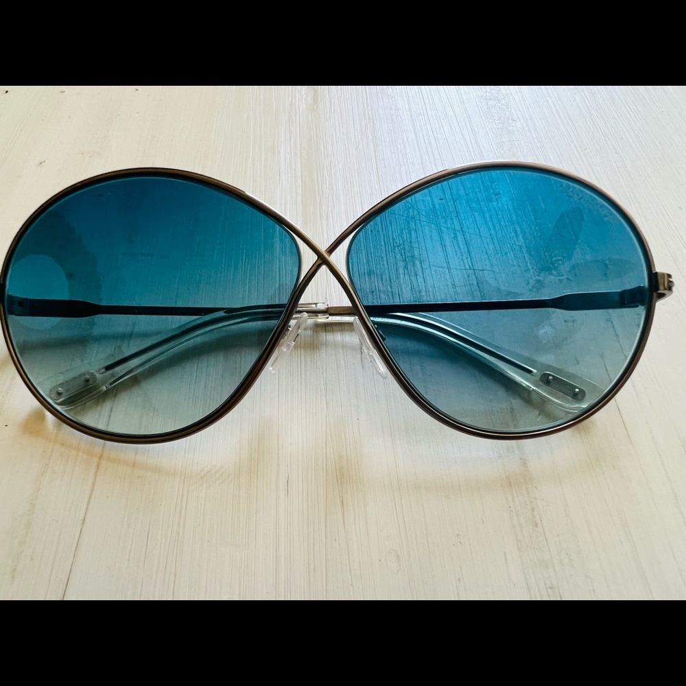 TOM FORD sunglasses with blue tinted lenses.